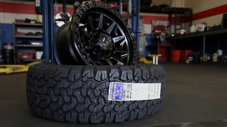Black tire and rim on the workshop floor