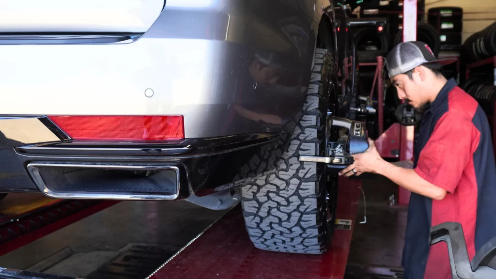 Vehicle on Hunter alignment machine during wheel inspection
