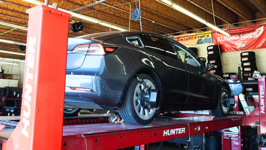 Vehicle on Hunter alignment machine during wheel inspection