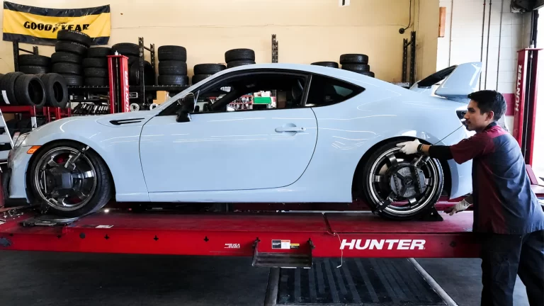 Sports car receiving professional wheel alignment service at Comtires