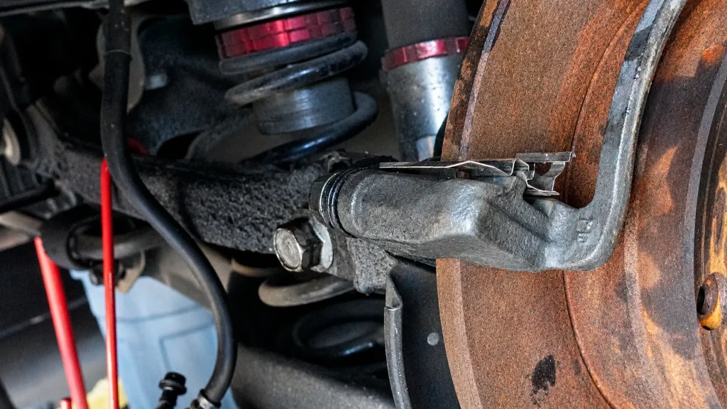 Close-up of fleet vehicle suspension and brake components during inspection