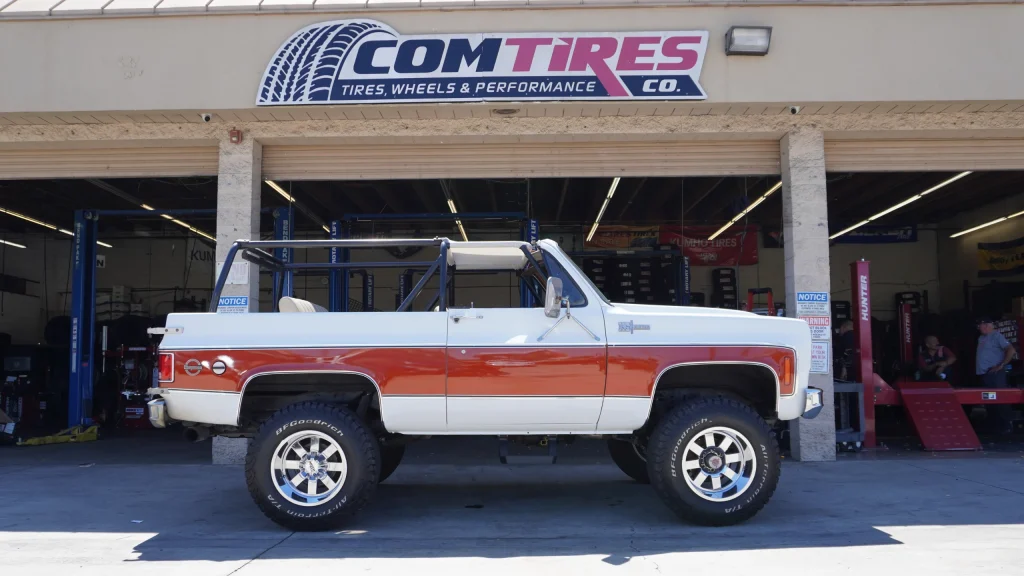Pickup truck with all-terrain tires outside Comtires in Ontario CA