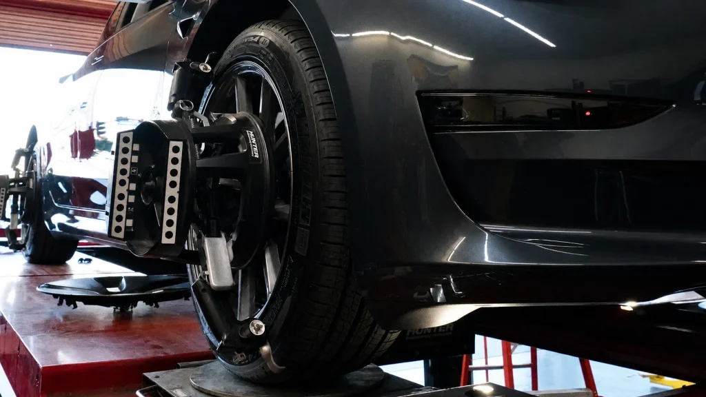 Wheel alignment sensors checking a fleet vehicle’s wheel angles